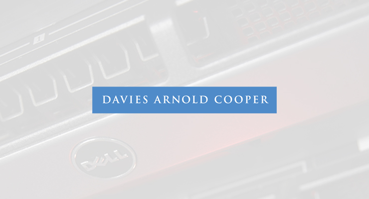 A blue rectangle with white text reading "DAVIES ARNOLD COOPER" is centred over a blurred background showing part of a Dell computer, referencing the Dell disaster recovery case study.