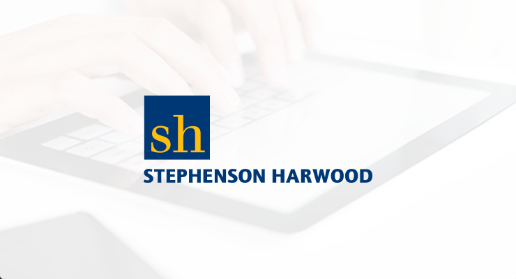 Stephenson Harwood logo with blue and yellow "sh" on a square, overlaid on a blurred image of hands typing on a tablet, referencing the Aerohive Enterprise Case Study.
