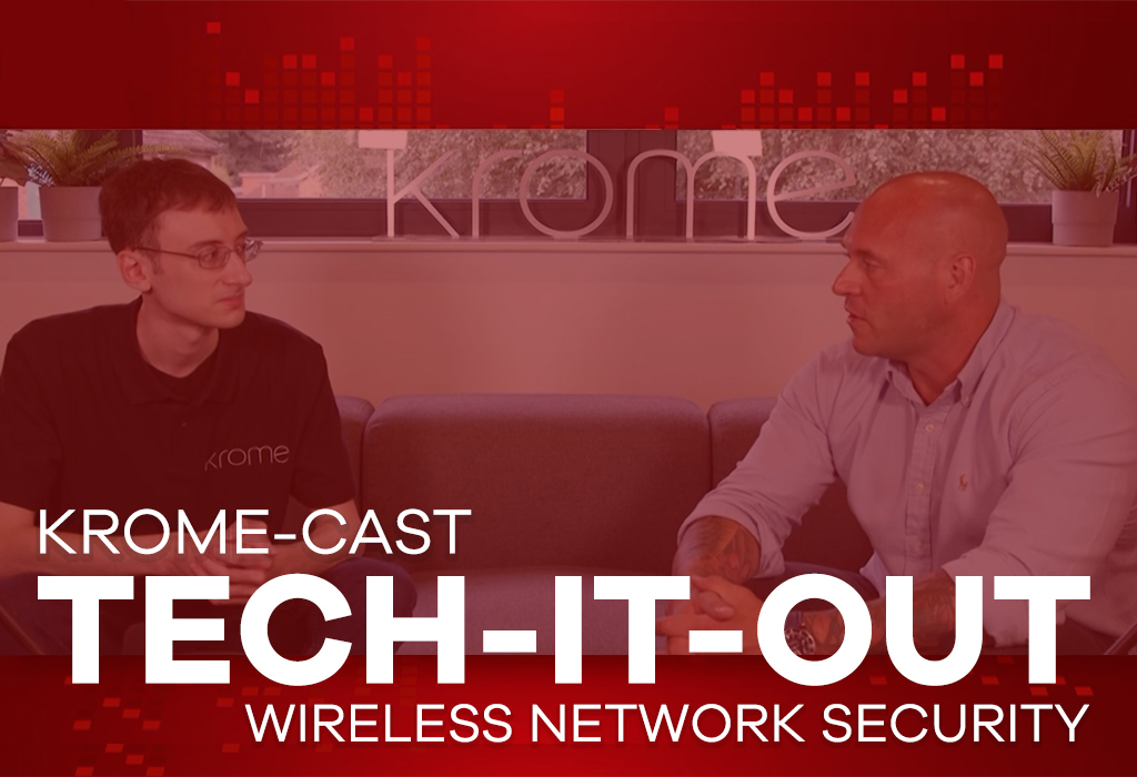 Two men having a discussion in a studio with "Corporate Wi-Fi Security tech-it-out: wireless network security" text displayed, one wearing glasses.