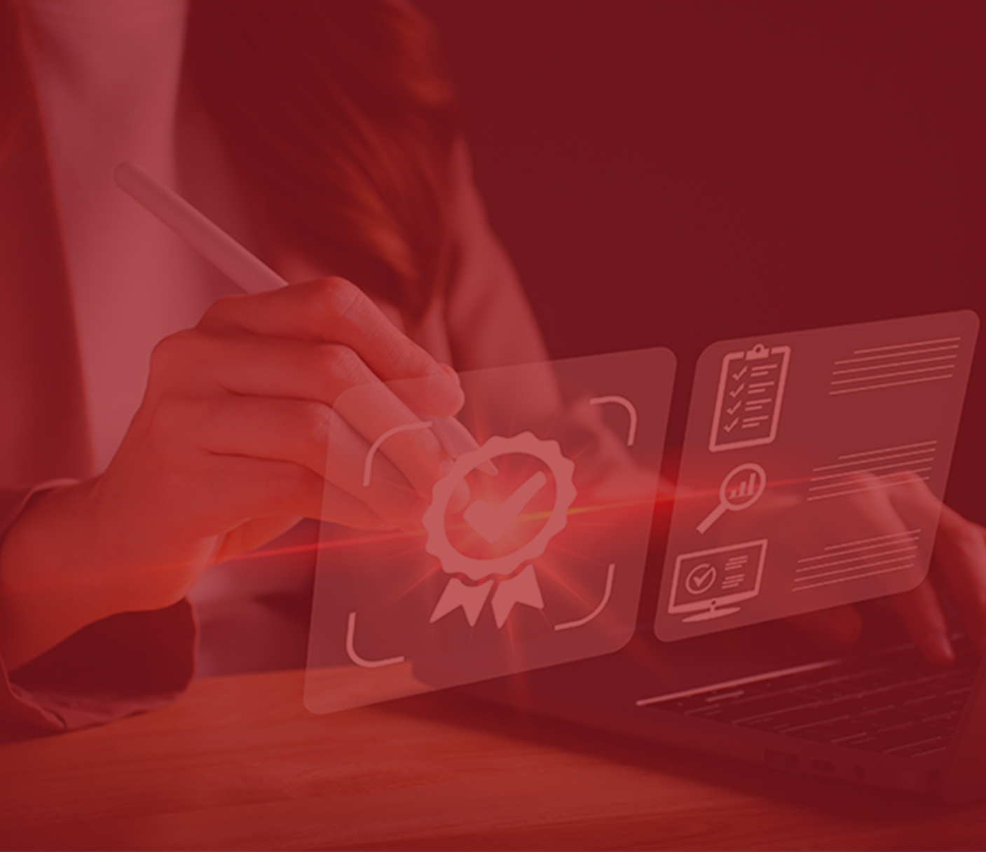 A person uses a stylus on a transparent virtual screen displaying a checkmark ribbon icon, charts, and documents near a laptop.